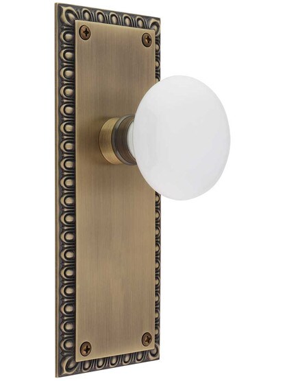 Ovolo Door Set with White Porcelain Knobs in Antique Brass.